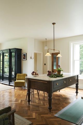 A large dining and lounge area with a movable oak table as the centrepiece.